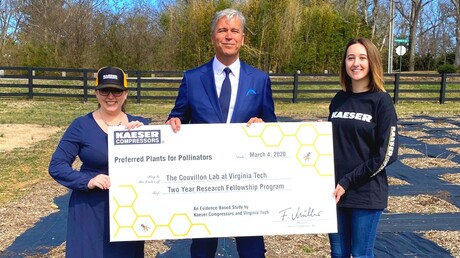 Frank Mueller presents check for pollinator study